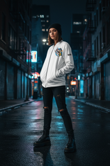 Woman wearing RAAR Looney Toons Bomber Jacket in white, urban streetwear lifestyle shot
